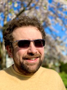 Martin Avila standing outside on warm, sunny day wearing sunglasses